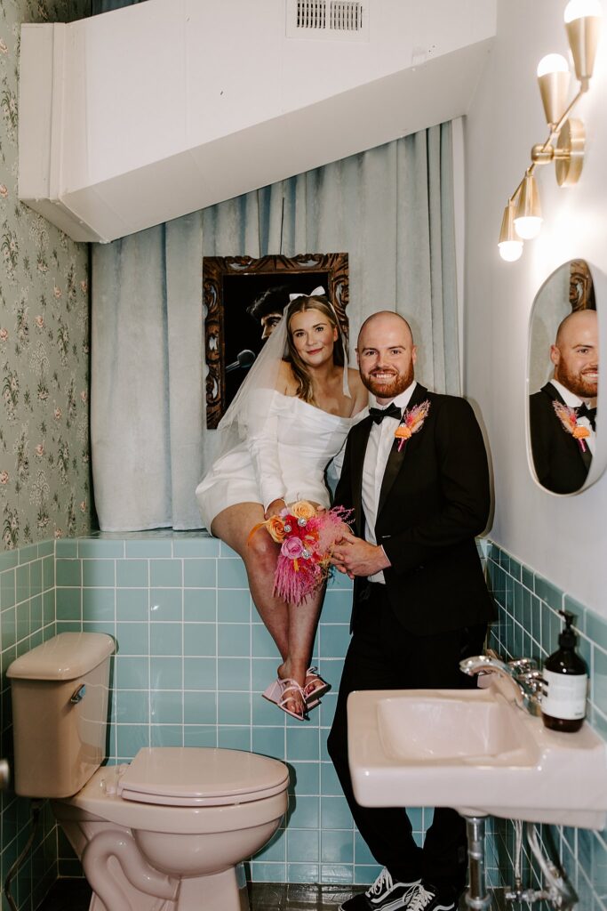 man and woman smile in bathroom at Sure Thing Chapel by Katelyn Faye Photography