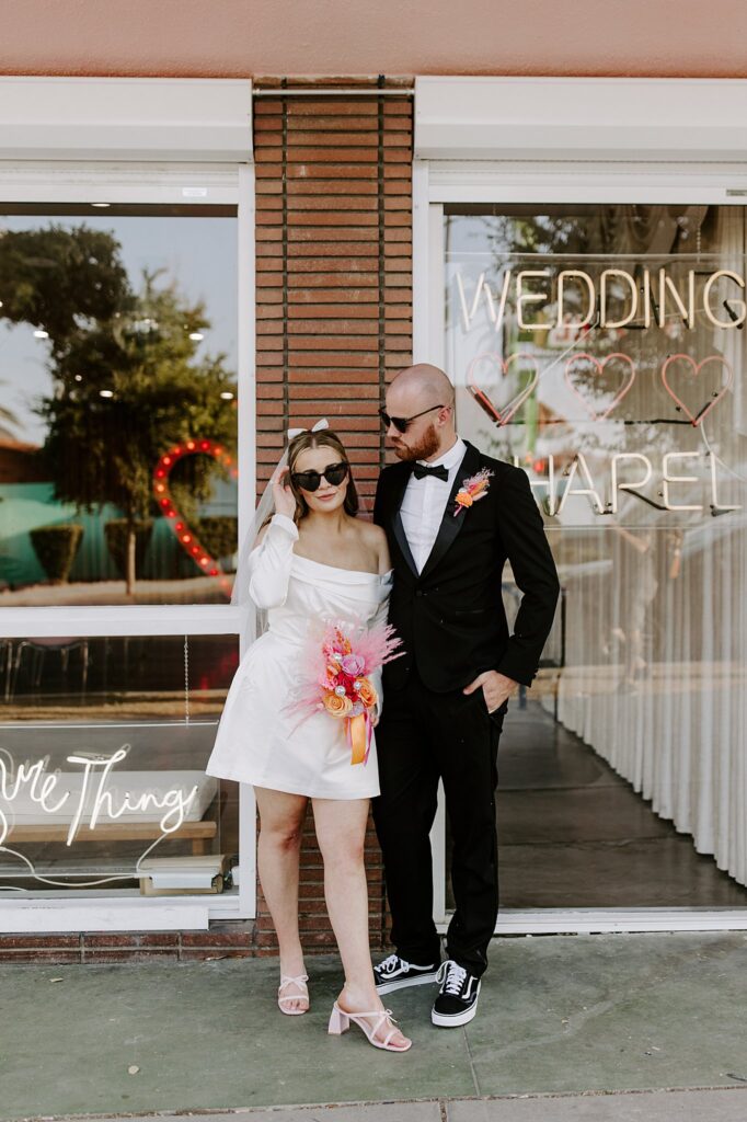 bride and groom wear sunglasses outside Sure Thing Chapel by Katelyn Faye Photography