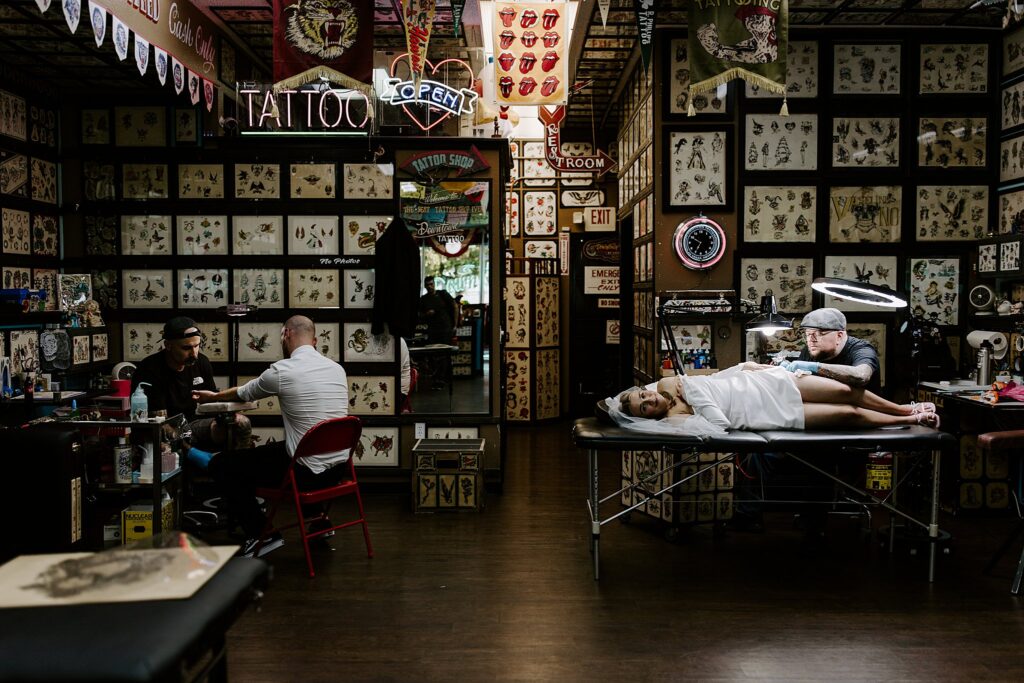 bride and groom get tattoos together by Katelyn Faye Photography