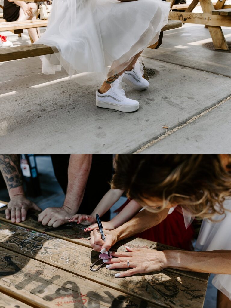 bride writes names on heart shaped lock by Katelyn Faye Photography 