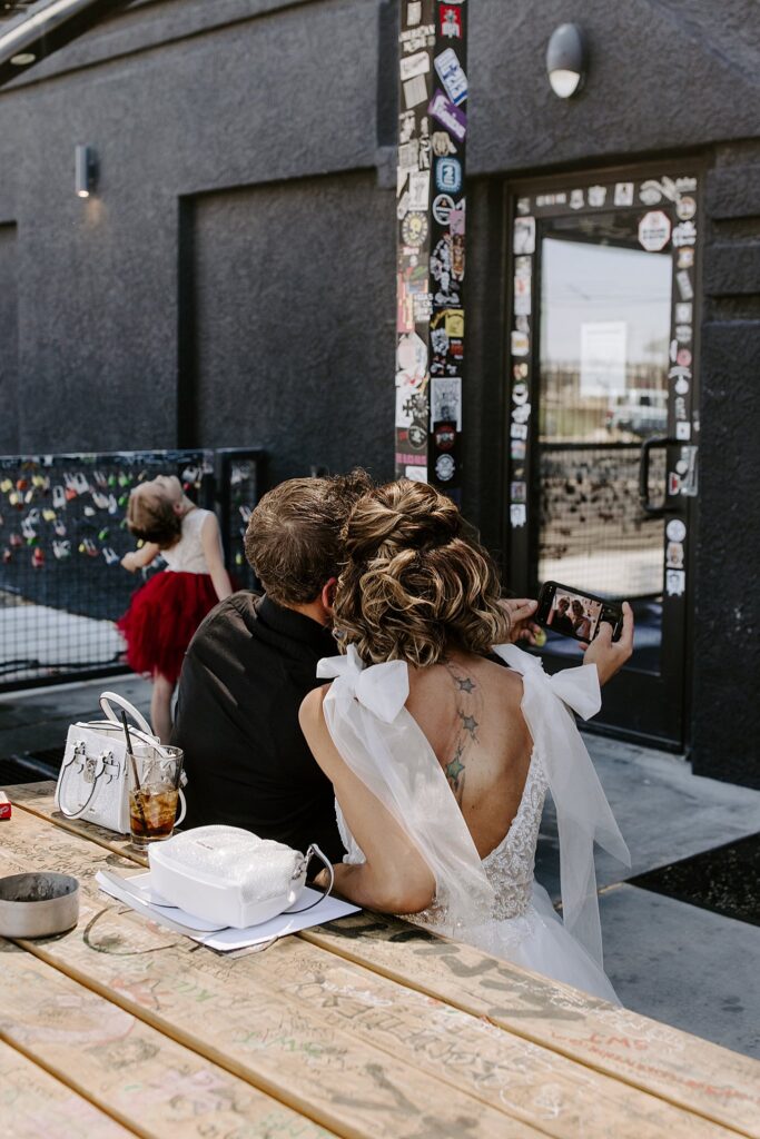 bride takes a picture with guest at the Punk Rock Museum