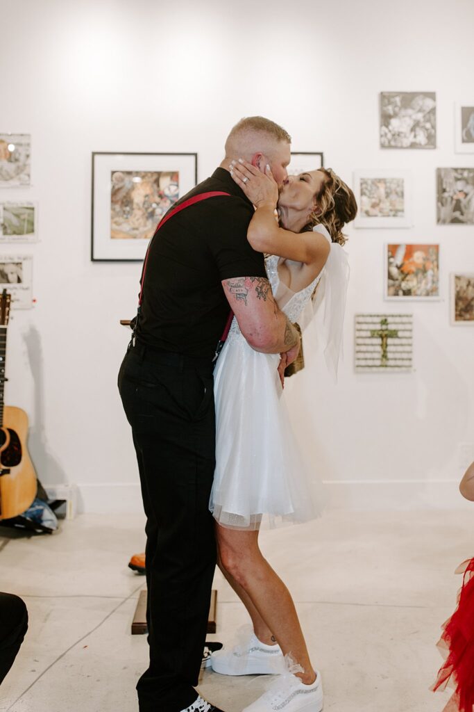 bride and groom kiss after ceremony at Punk Rock Museum