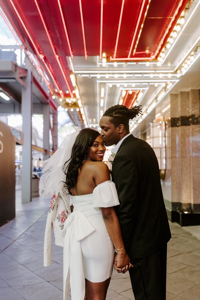 man kisses bride on the forehead by Katelyn Faye Photography