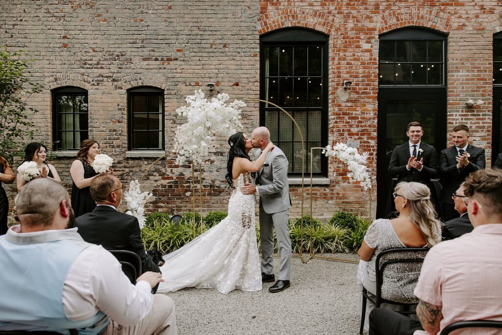 bride and groom kiss at the altar during the ceremony by Katelyn Faye Photography