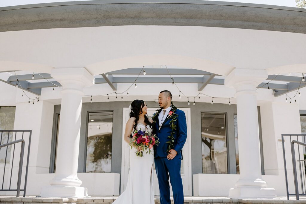 bride and groom look at each other smiling by Katelyn Faye Photography