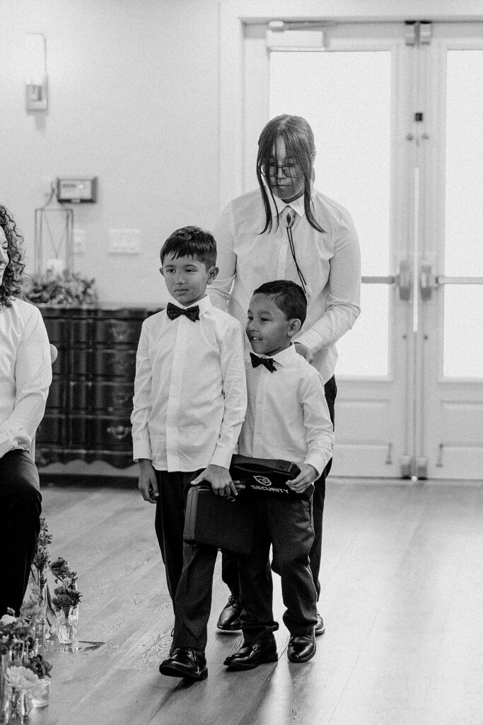 ring bearers walk down aisle by Katelyn Faye Photography