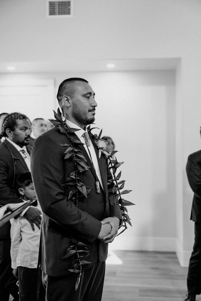 groom watches bride walk down the aisle at colorful ceremony at Adorn