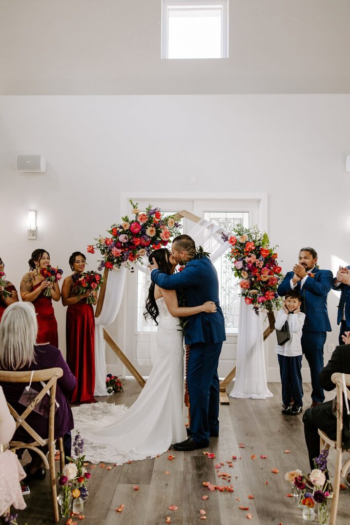 couple kisses at altar by Las Vegas wedding photographer