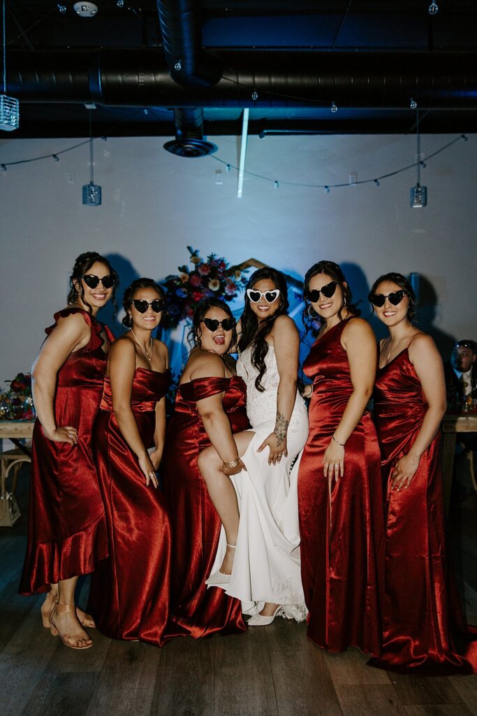 bridesmaids wear heart shaped sunglasses with bride by Katelyn Faye Photography