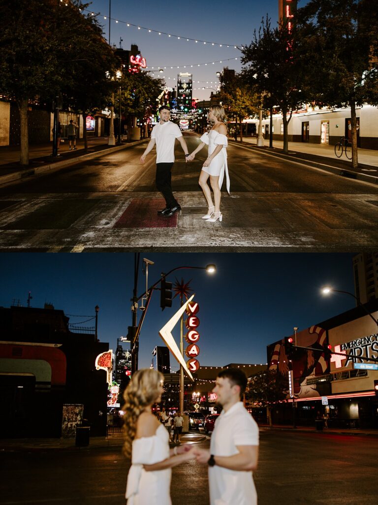 engaged couple walks across lit up street by Katelyn Faye Photography