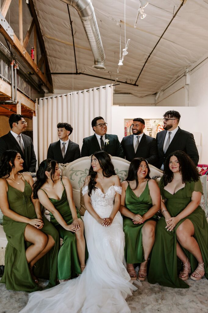 wedding party sits on a couch together at The Doyle