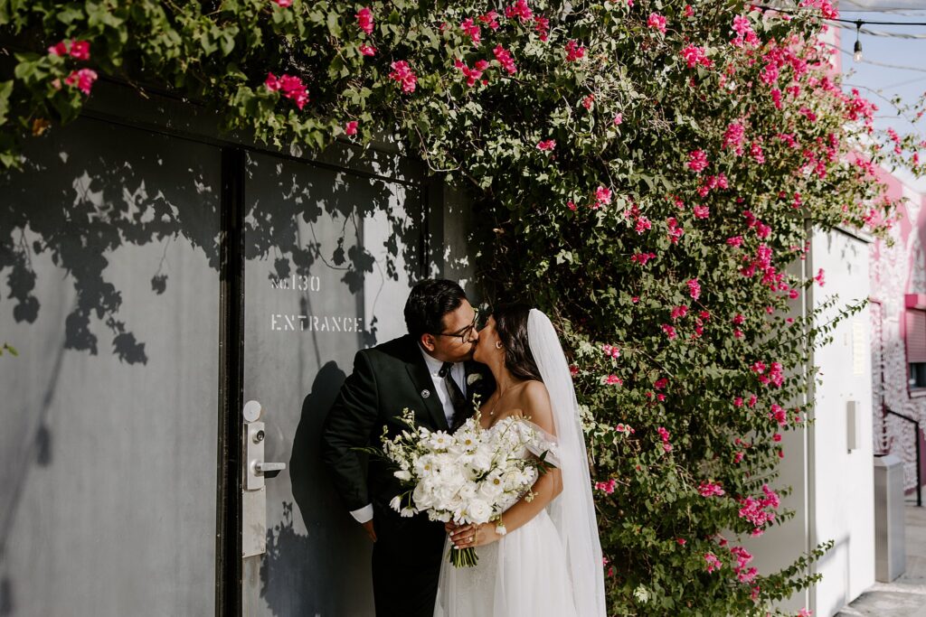 bride and groom share a kiss outside The Doyle