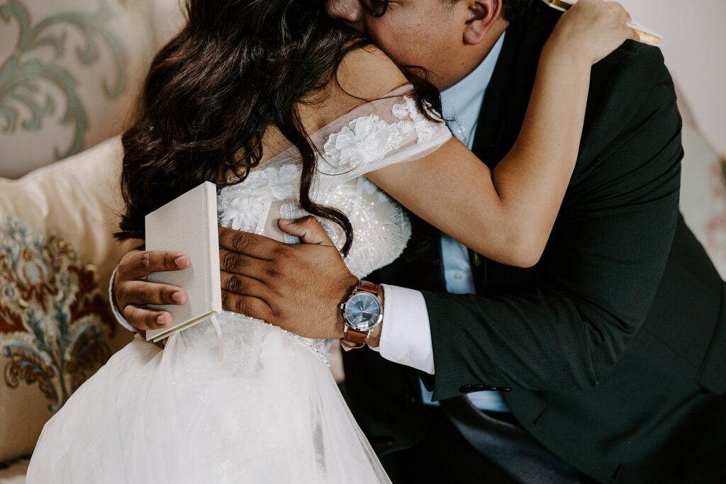 man hugs woman after they share personal vows before their ceremony at The Doyle