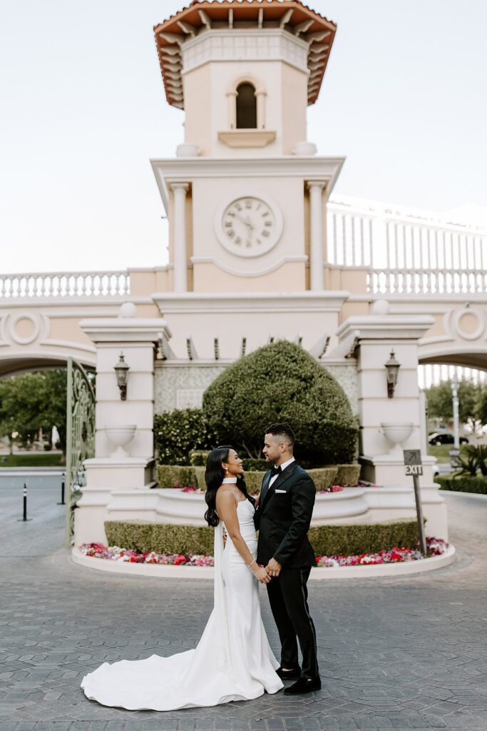 man and woman hold hands at entrance by Las Vegas wedding photographer