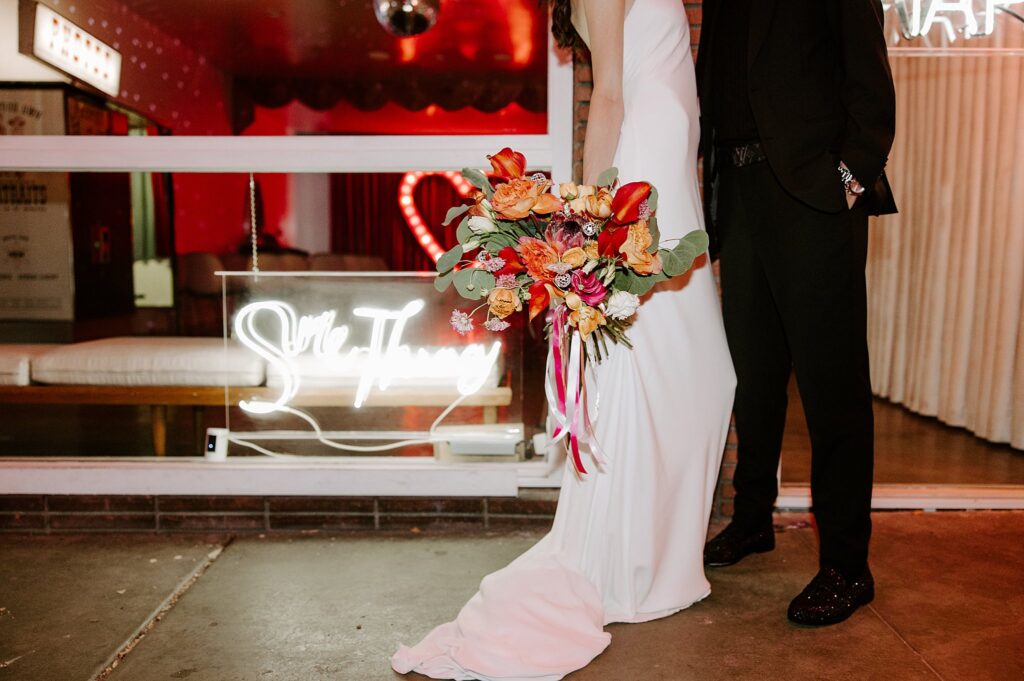 woman in white dress holds bridal bouquet down at her side at Sure Thing Chapel wedding