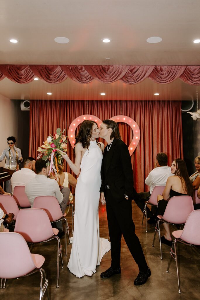 newlyweds hiss as they walk down aisle at Sure Thing Chapel wedding