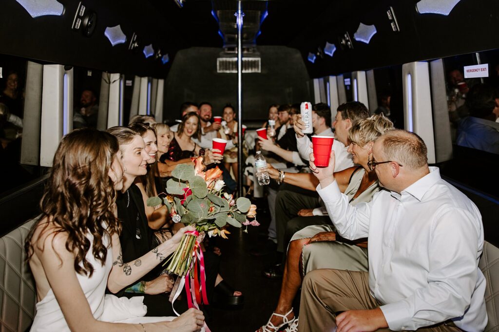 guests toast in party bus after ceremony by Las Vegas elopement photographer