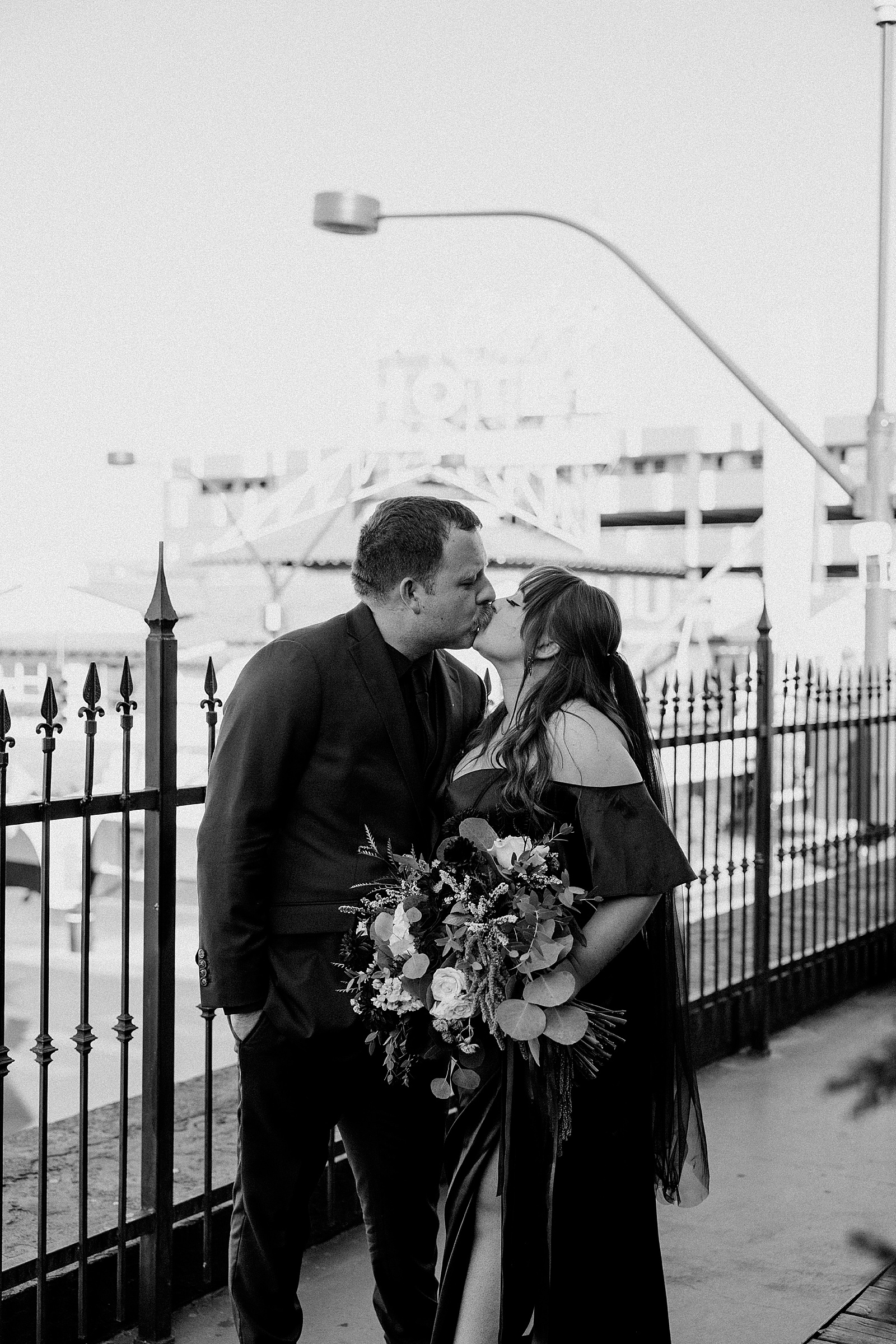 newlyweds share kiss on balcony by Katelyn Faye Photography