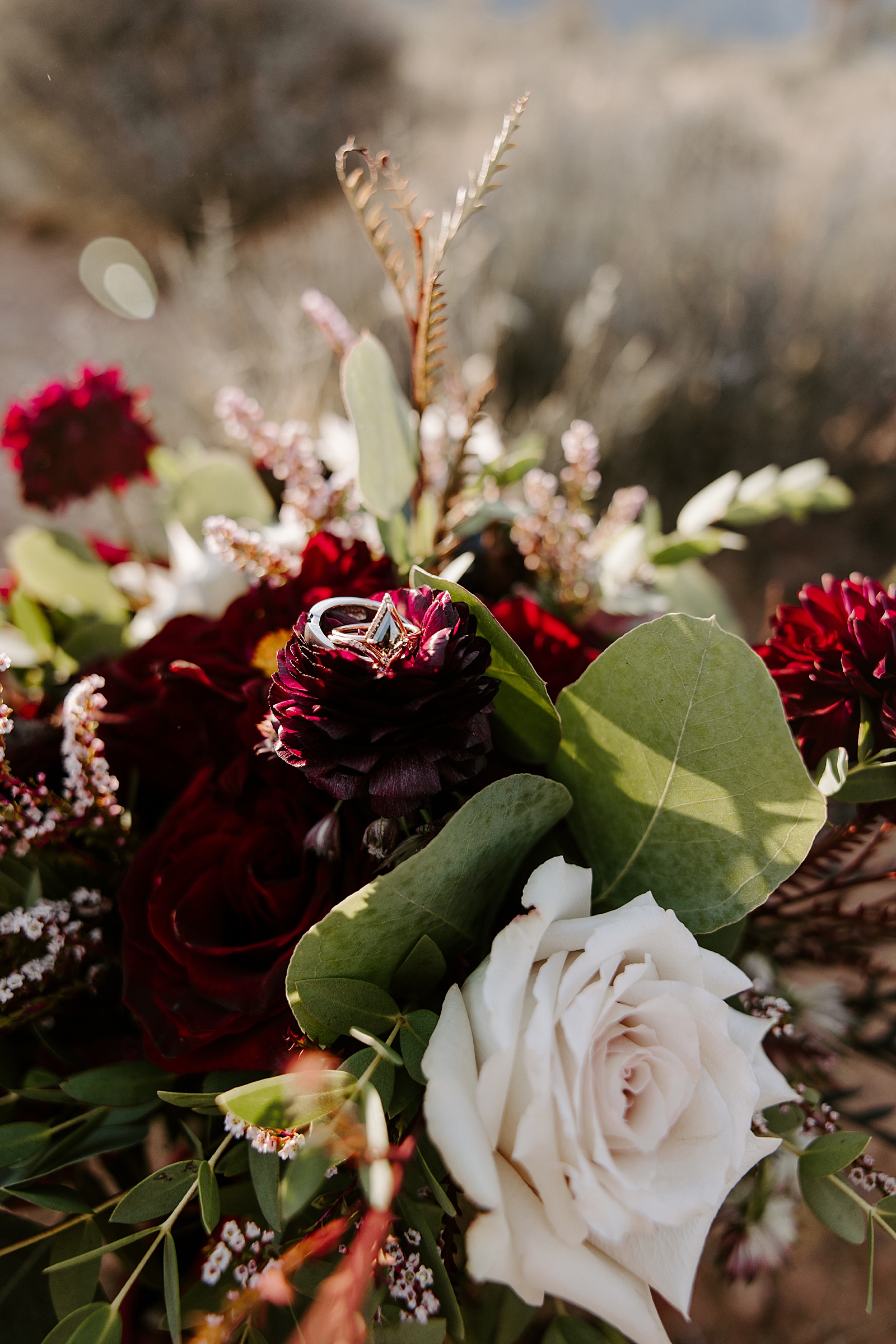 diamond ring sitting on ruby flower by Las Vegas Elopement Photographer