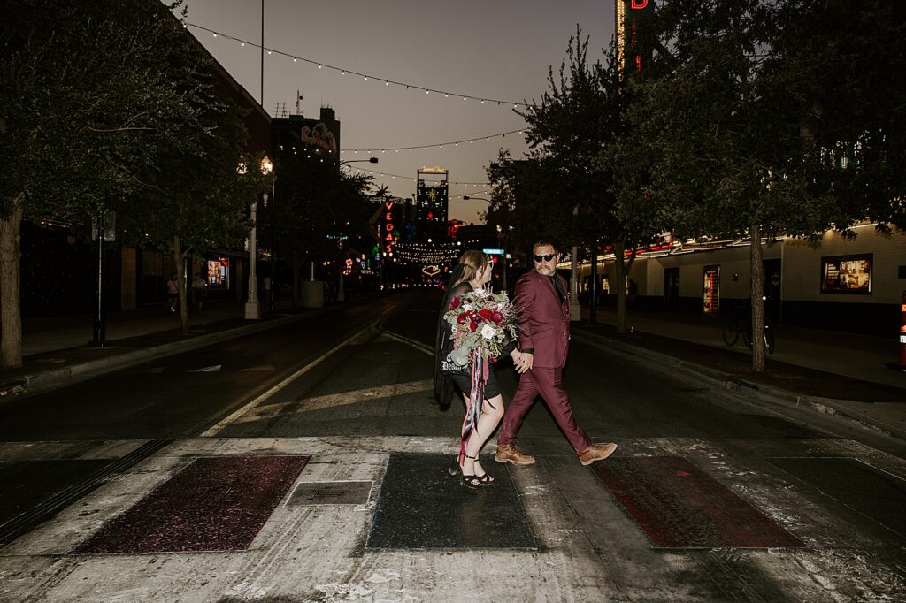 newlyweds in sunglasses walk across sidewalk by Katelyn Faye Photography 