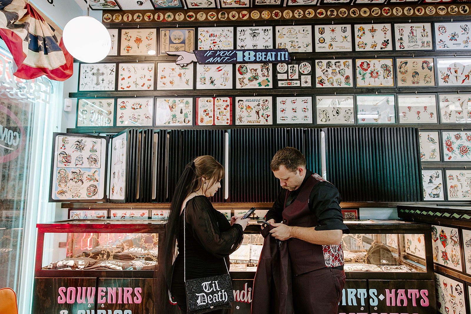 man and wife look over flash tattoos by Katelyn Faye Photography 