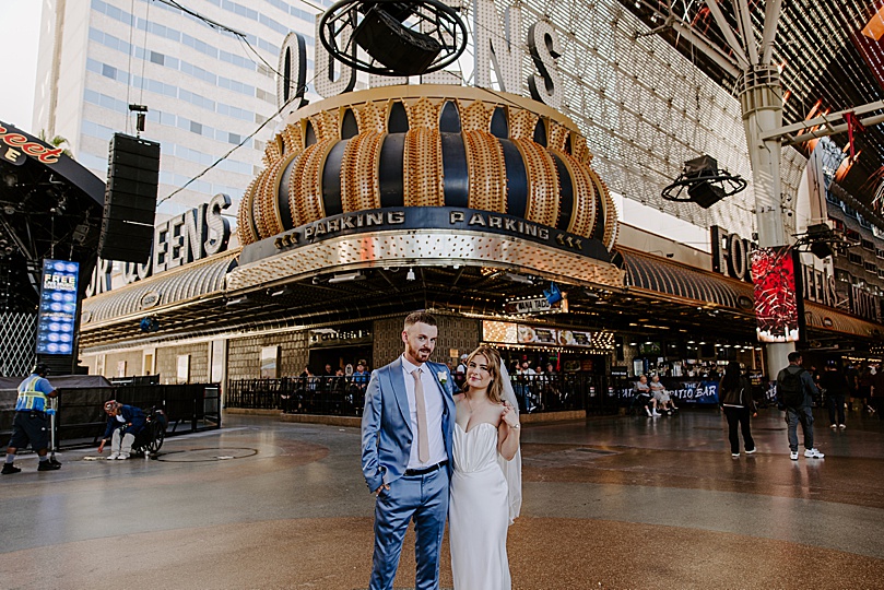 husband and wife on sparkling streets by Las Vegas wedding photographer