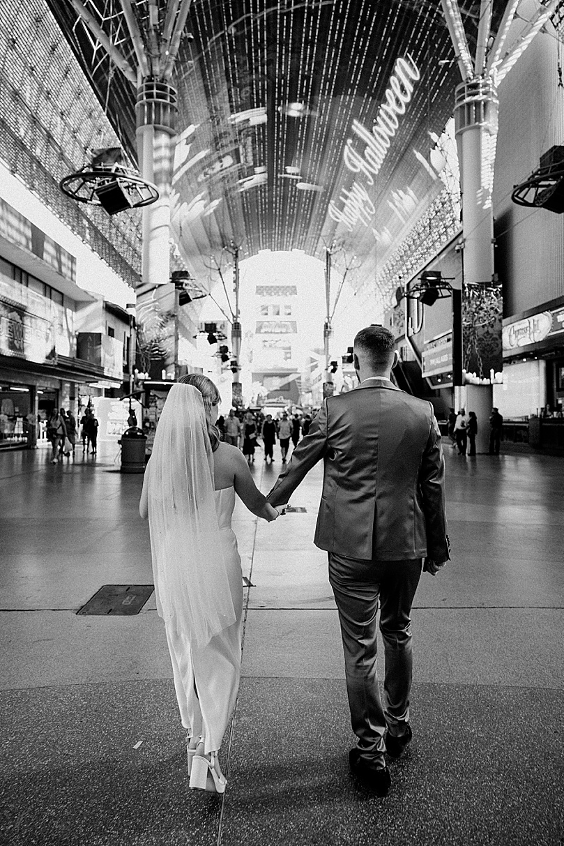 newlyweds walk down a street for Post-Elopement Couples Shoot