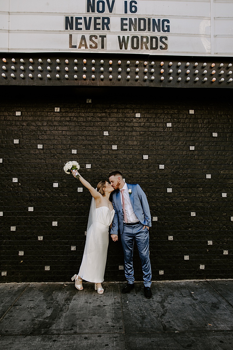 bride throws hand in the air in celebration during Post-Elopement Couples Shoot