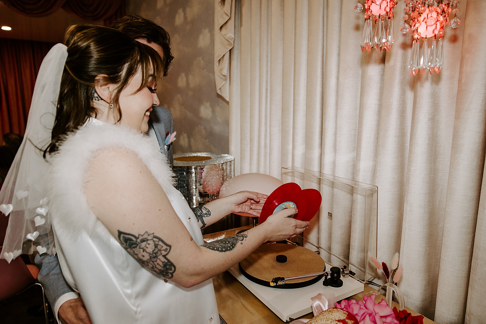 newlyweds pick out heart shaped record by Katelyn Faye Photo