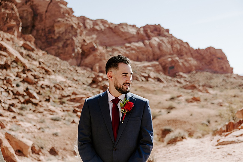 groom watches bride walk down aisle by Las Vegas Elopement Photographer