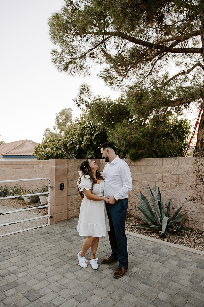 newlyweds share a smile under a tree after Valley of Fire elopement