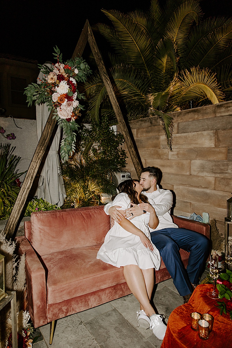 husband and wife cuddle on velvet couch after Valley of Fire elopement