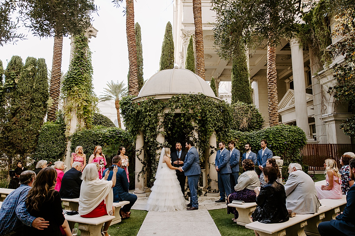 Bride and groom holding hands at ceremony by Katelyn Faye Photography