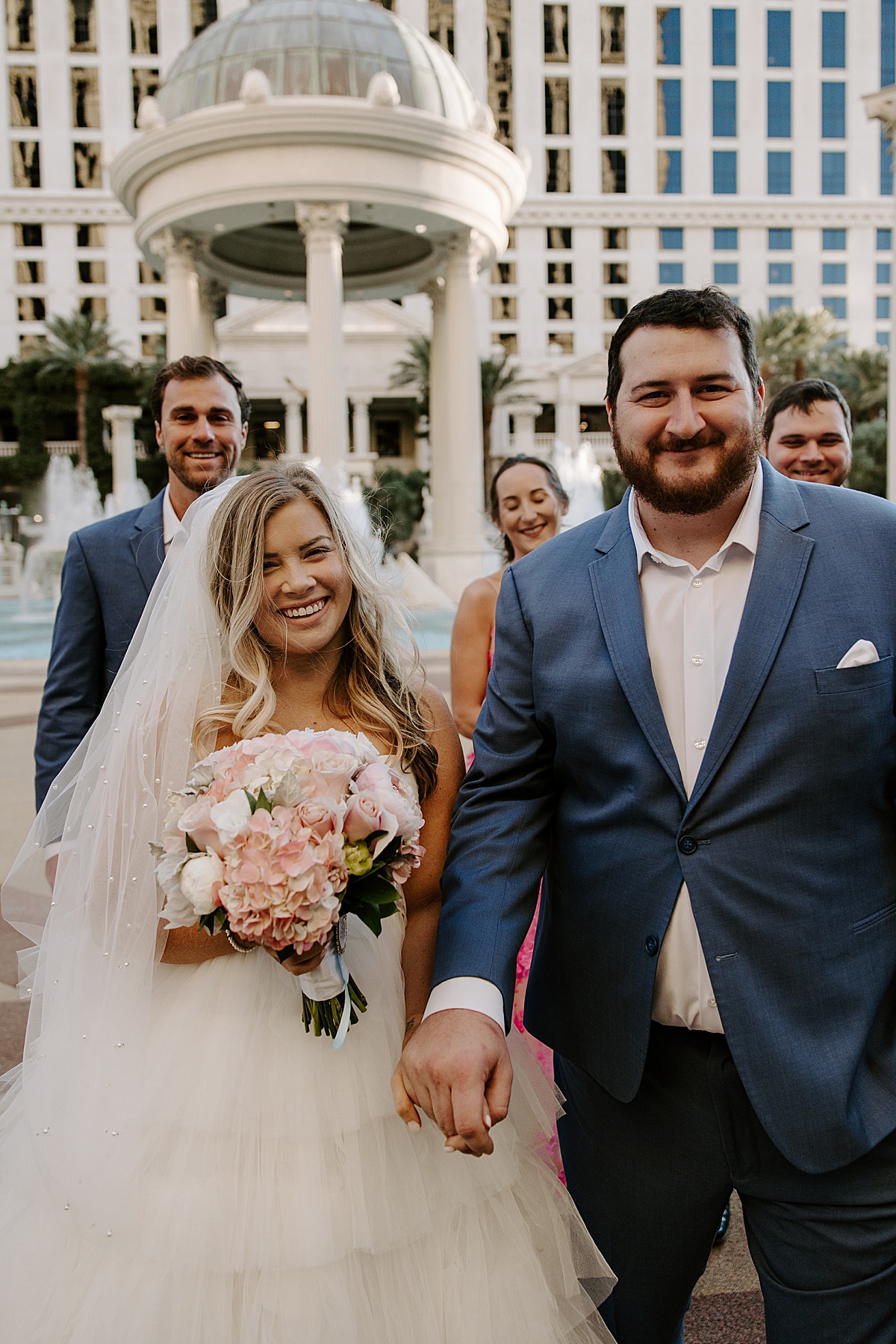 Bride holds pink wedding bouquet by Las Vegas Wedding Photographer