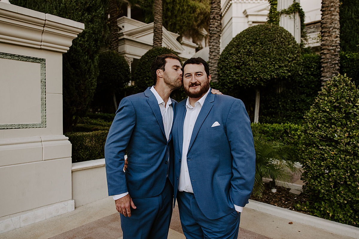 Groomsmen jokes around in navy blue tux by Katelyn Faye Photography