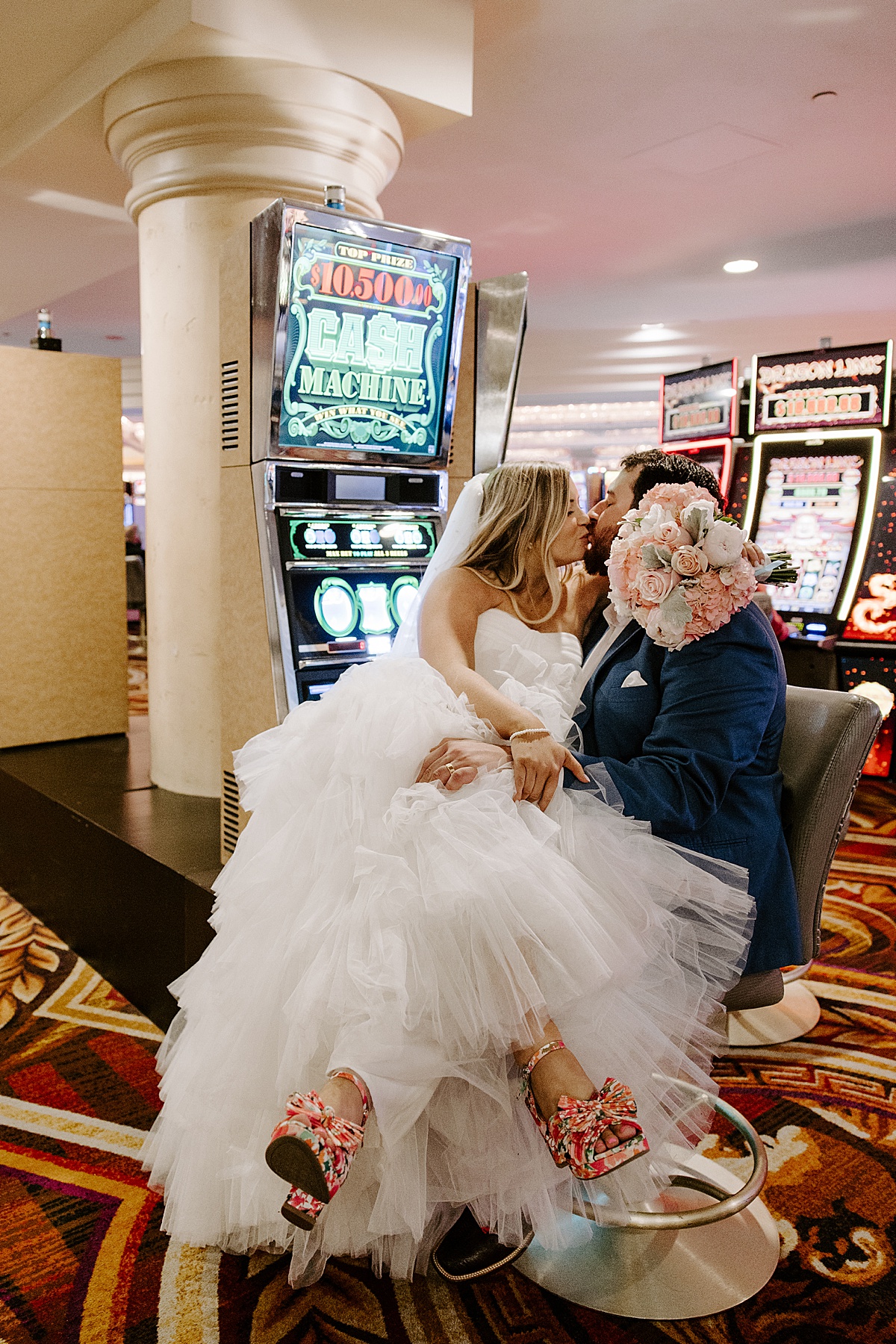 Husband holds wife in lap at casino inside Caesars Palace Venus Garden 