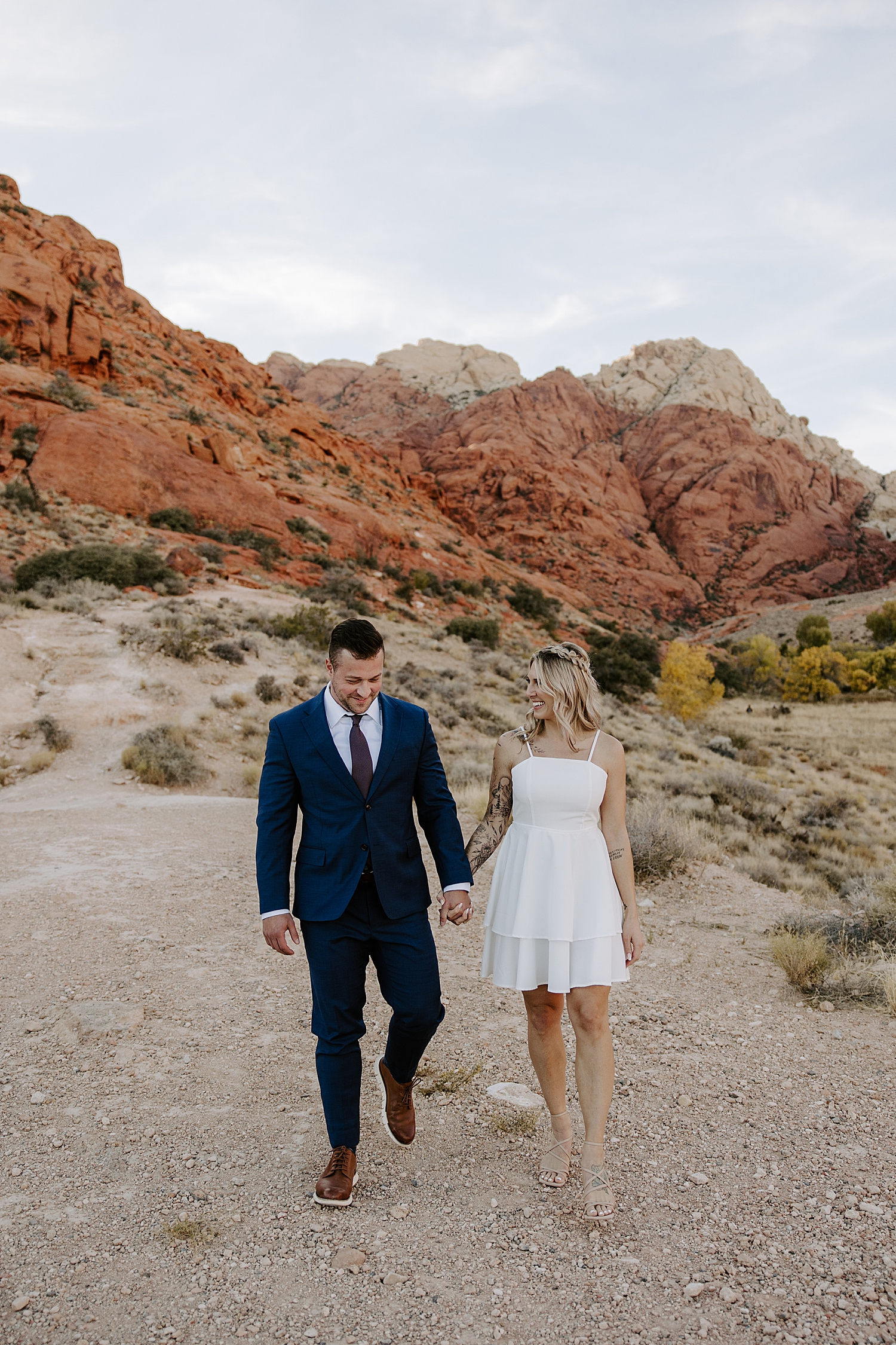 man and woman hiking in dress & suit by Katelyn Faye Photo