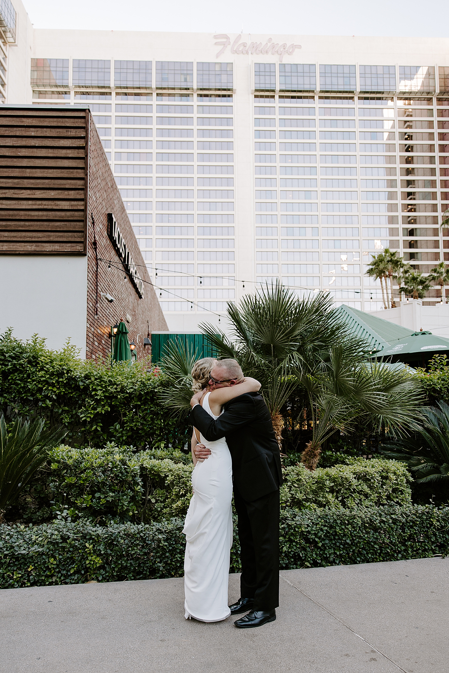 man hugs his bride-to-be at hotel by Katelyn Faye Photo