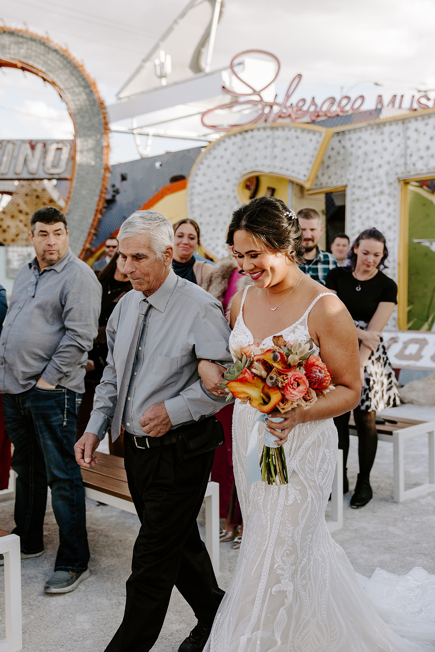 bride walks down the aisle outdoors by Las Vegas wedding photographer 