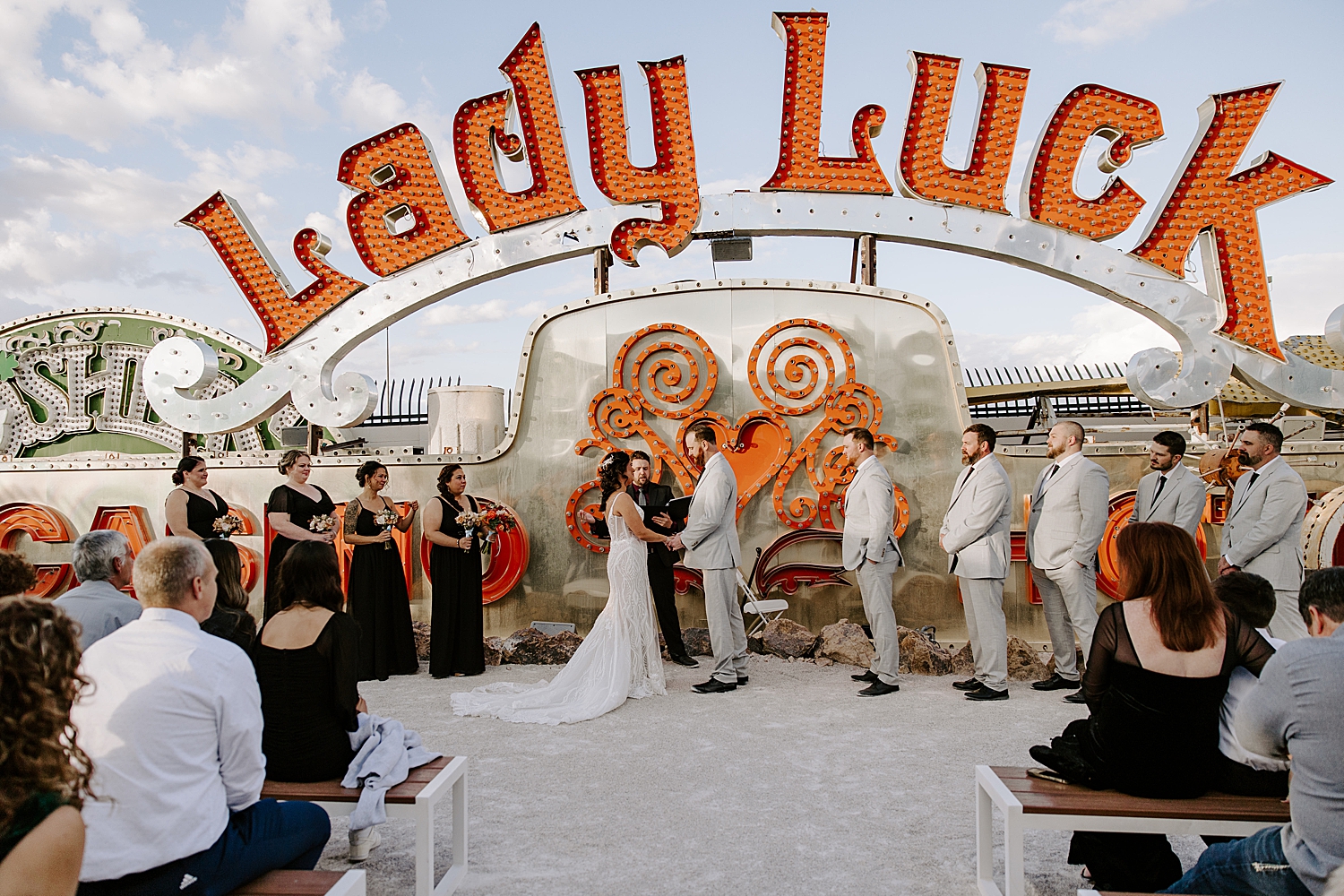 bride and groom hold hands at the alter for Neon Museum Ceremony