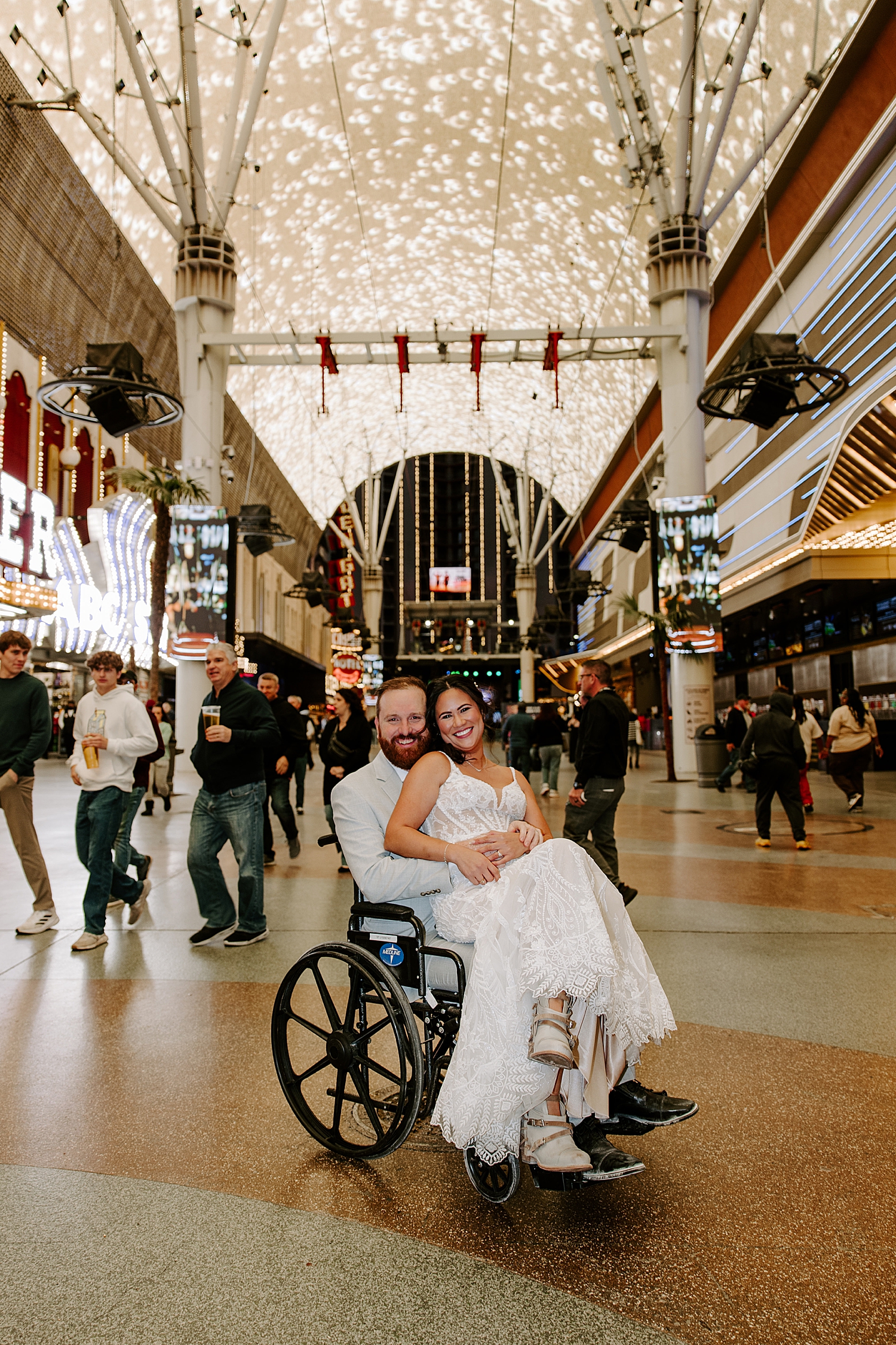 woman sits on man's lap in wheelchair by Katelyn Faye photo 