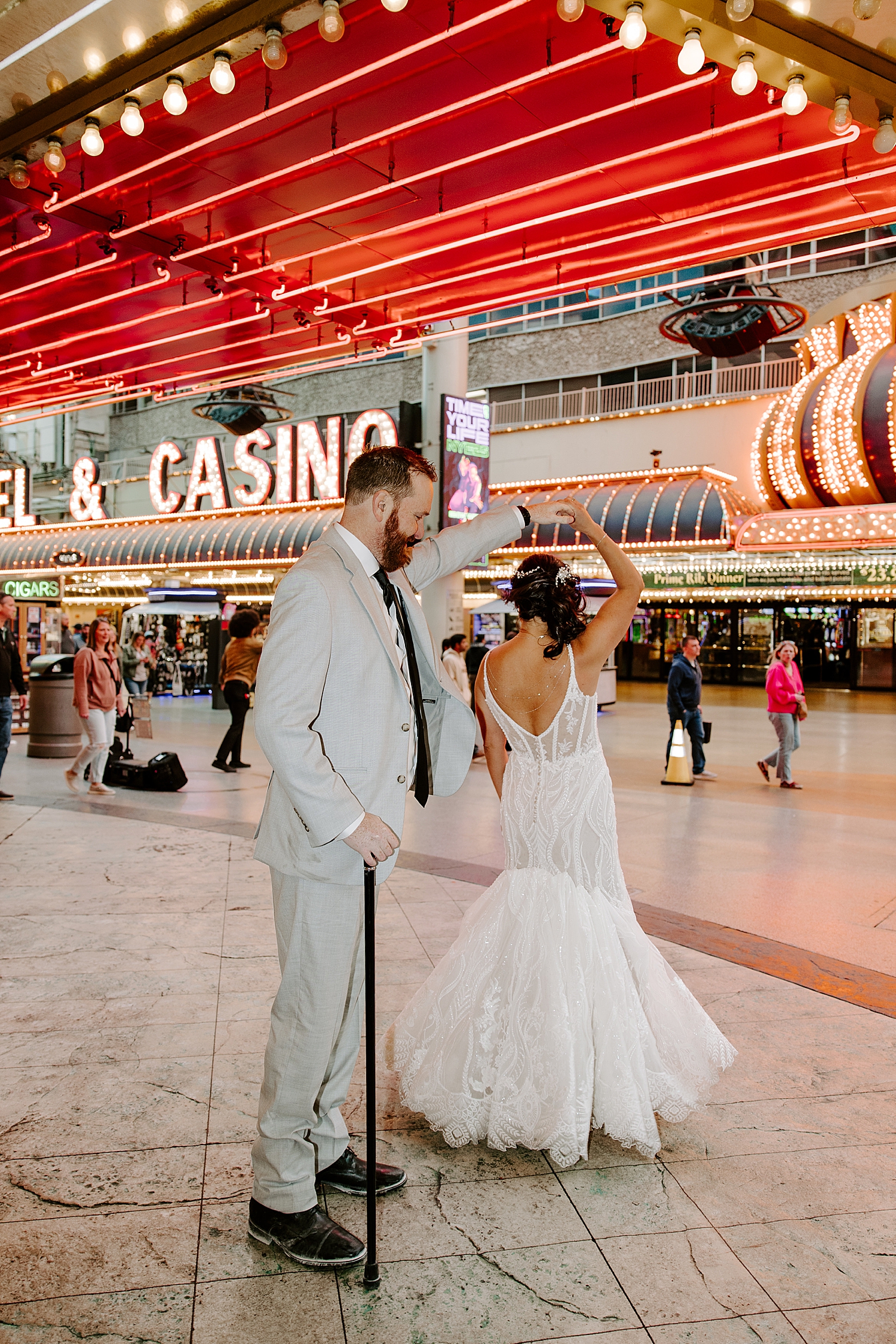 man spins his new wife on the street by Las Vegas wedding photographer 