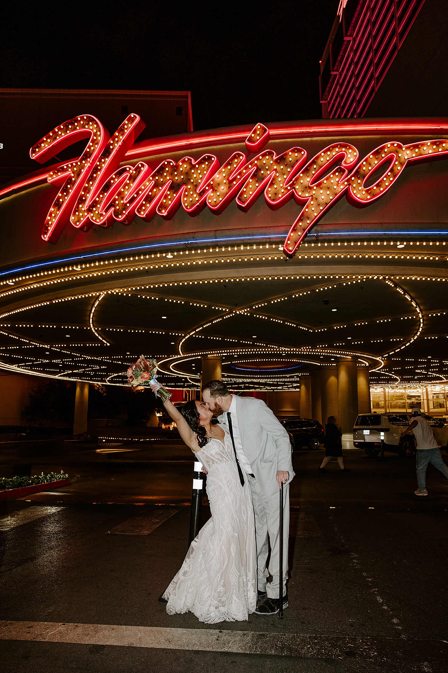 newlyweds celebrate under flamingo sign after Neon Museum Ceremony