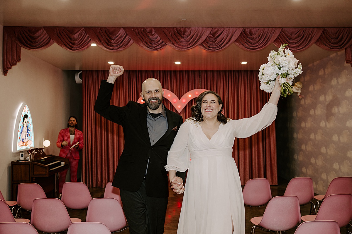 couple celebrates after saying i do at intimate chapel elopement