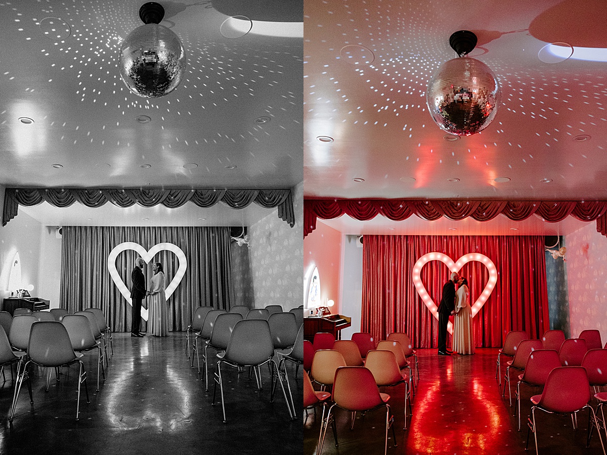 couple shares a kiss infront of heart shaped marquee by las vegas wedding photographer