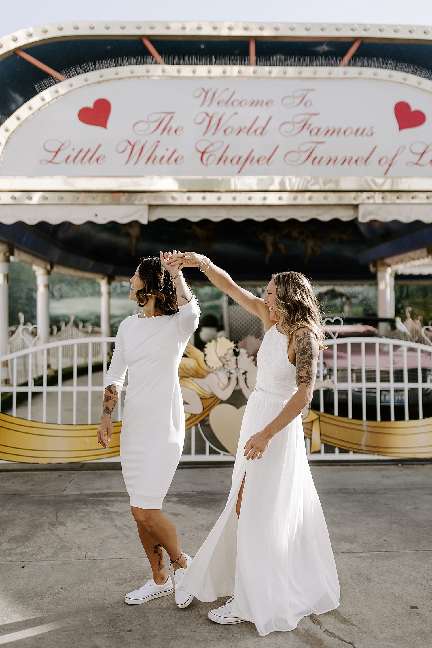 bride spins her wife in front of Vegas chapel