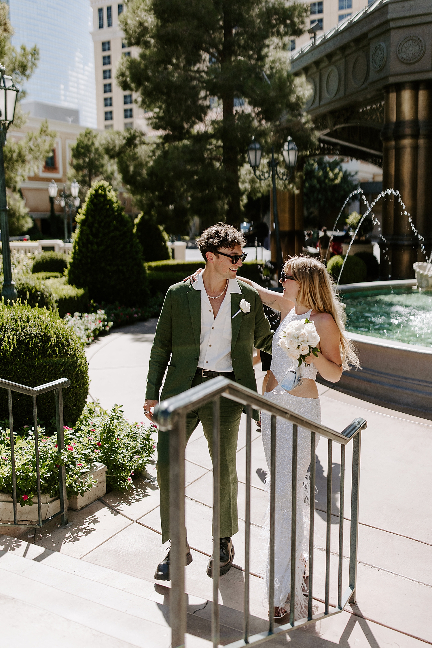 couple embraces in front of fountains for Bellagio reception