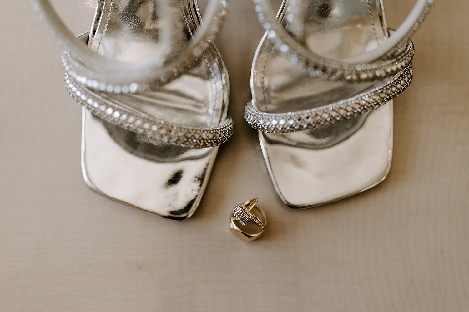 diamond ring in front of silver shoes by Las Vegas wedding photographer