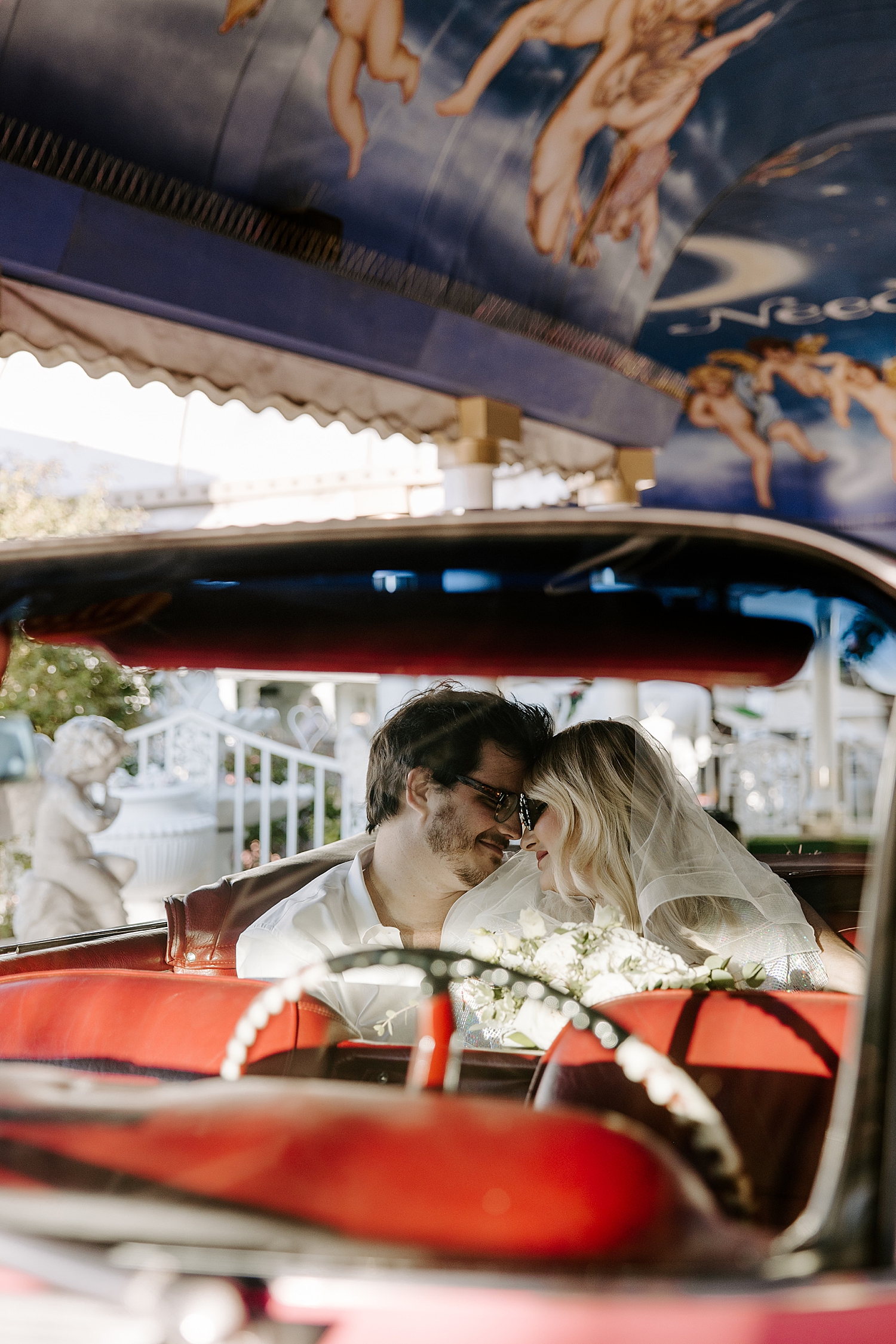 newlyweds lean in for embrace in car by Katelyn Faye Photo