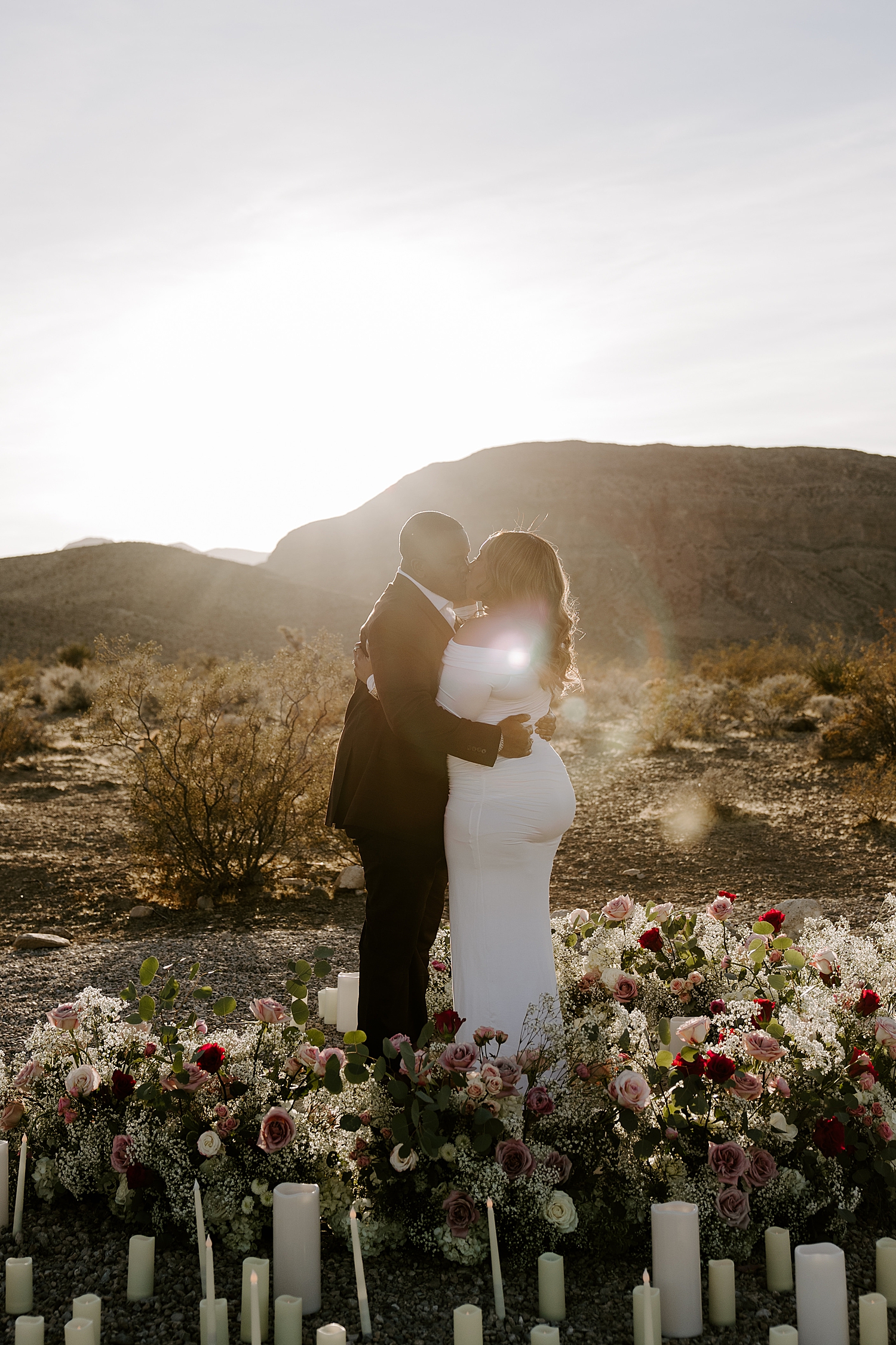 man kisses his new fiance in golden hour for desert surprise proposal